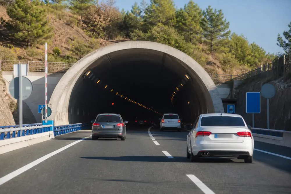 Boca de un túnel de carretera con vehículos entrando